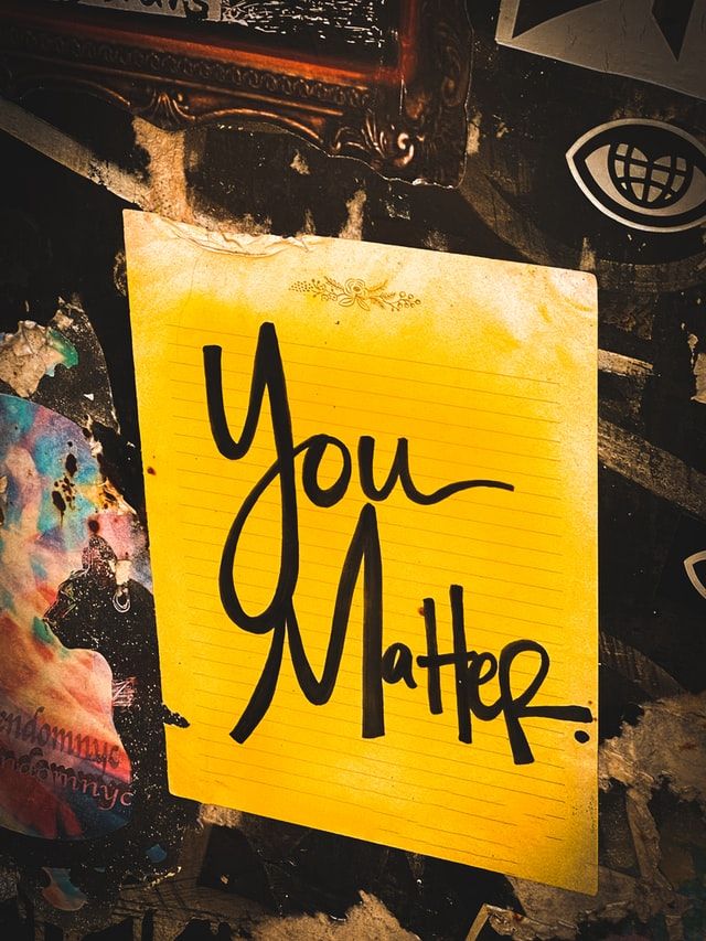 yellow paper sign that says you matter