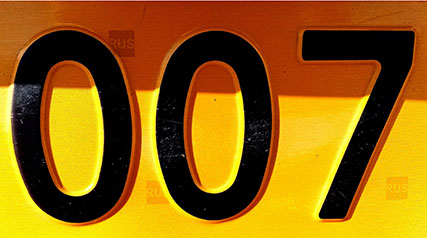 license tag in yellow and orange with the number 007