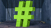 lime green 3-D hashtag symbol inside a dark shipping container