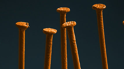 rusty orange building nails shot close up