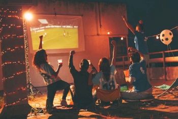 friends outdoors watching bank sponsored sports game